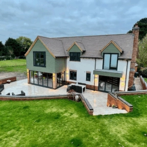 Modern family home with expansive bifold doors and Juliet balconies in a greenbelt location – highlighting large glazing features often subject to planning rules.